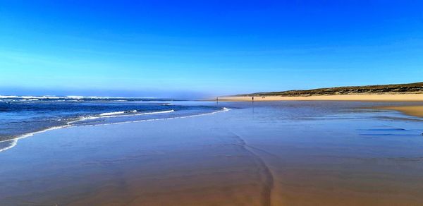 Scenic view of sea against clear blue sky