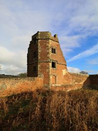 Low angle view of old building against sky