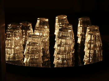 Close-up of glass bottles against black background