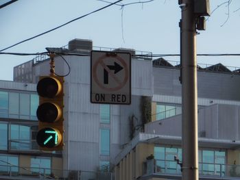 Low angle view of road signs against sky