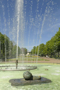 Water splashing in fountain against sky