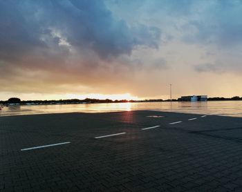 View of airport runway against sky during sunset