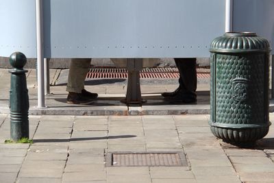 Low section of men urinating at public restroom