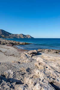 Scenic view of sea against clear blue sky