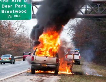 A car is on fire on the side of the road in long island new york