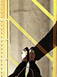 Low section of woman standing on tiled floor