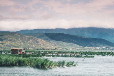 Scenic view of lake and mountains against sky