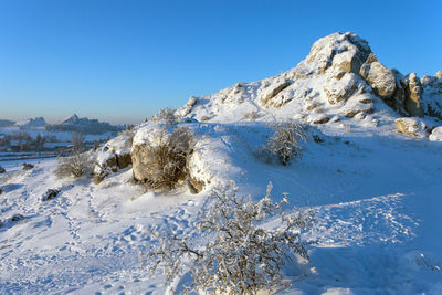 Scenic view of snowcapped mountains against clear blue sky