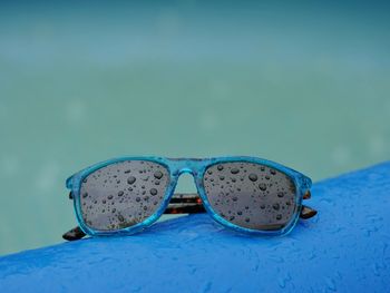 Close-up of sunglasses on blue water