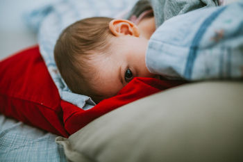 Portrait of baby girl lying on bed