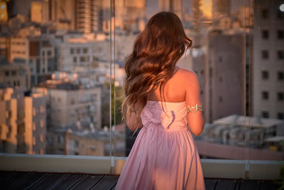 Rear view of woman standing in city