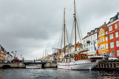 Boats in river with buildings in background