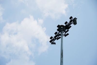 Low angle view of floodlight against blue sky