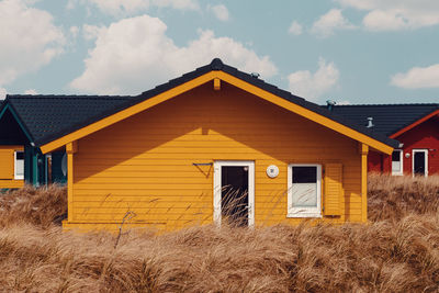 Exterior of house on field against sky