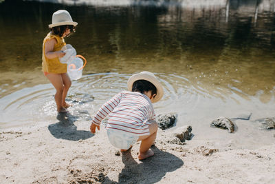 Brother and sister playing at the river