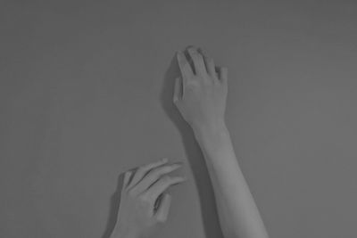 Close-up of hand against wall