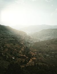 Scenic view of landscape and buildings against sky
