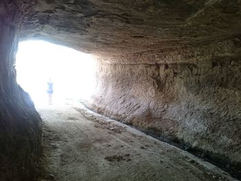 Woman standing in tunnel