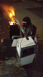 Man sitting in car at night