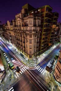 High angle view of city street and buildings at night