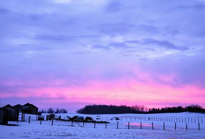 Scenic view of snow field against sky during sunset