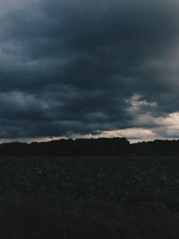 Silhouette landscape against cloudy sky