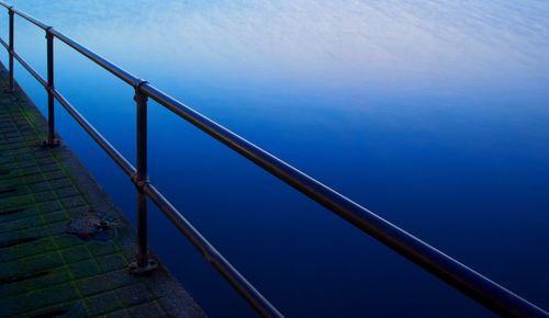 Railing on pier over lake