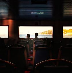 Rear view of people sitting in a ferry boat