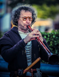 Mid adult man playing flute