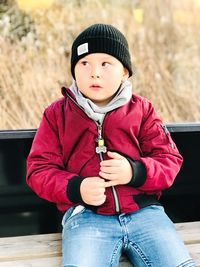 Boy sitting on bench