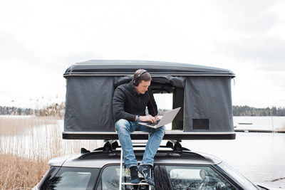 Man working from a tent with a view to social distance from the office