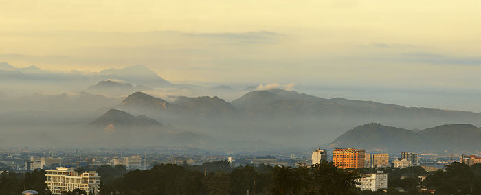 High angle view of buildings and mountains against sky