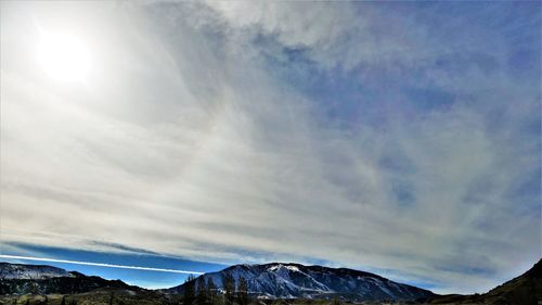 Low angle view of snowcapped mountains against sky