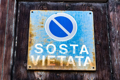 Close-up of arrow sign on road