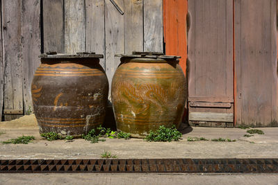 Close-up of old food on table against wall