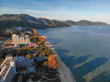 High angle view of townscape by sea against sky