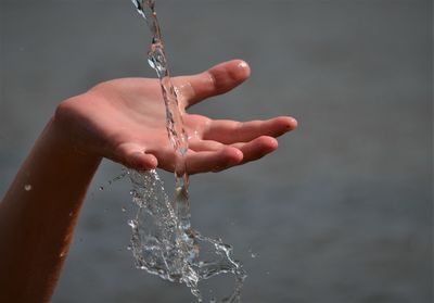 Close-up of cropped wet hand