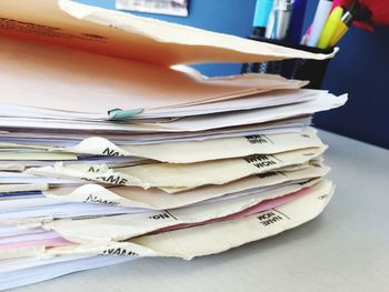 Close-up of stacked papers on table