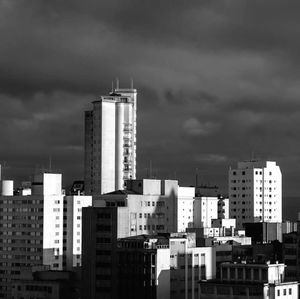 Modern buildings against cloudy sky