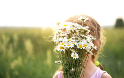 Close-up of hand holding flowers