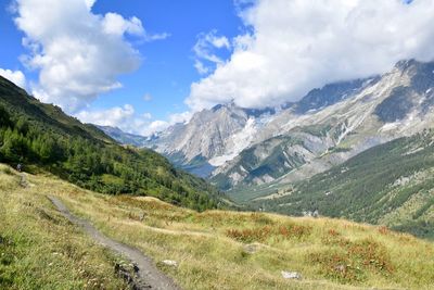 Scenic view of mountains against cloudy sky
