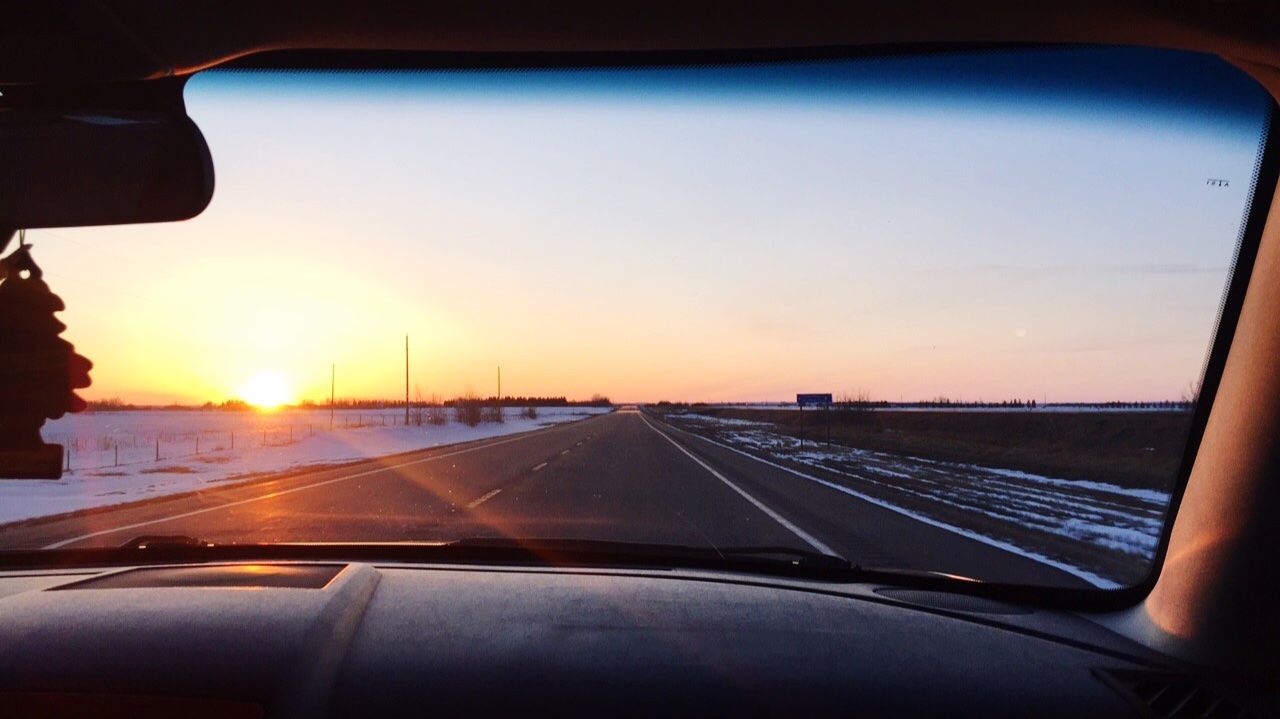 transportation, glass - material, car, sky, vehicle interior, mode of transportation, sunset, transparent, windshield, land vehicle, motor vehicle, car interior, road, indoors, travel, nature, on the move, no people, dashboard, orange color, car point of view, road trip