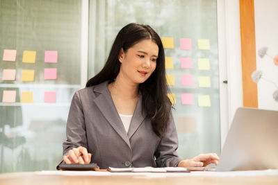 Portrait of young businesswoman working at home