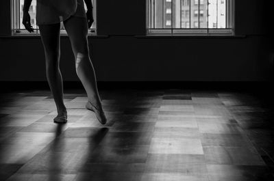 Low section of woman standing on window