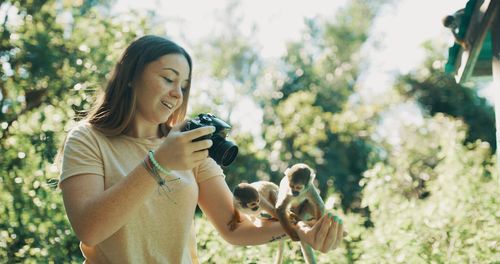 Midsection of woman holding plant