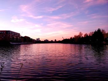 Scenic view of river against sky at sunset