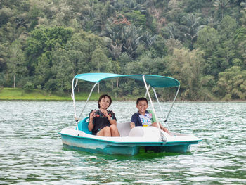 People sitting on boat in water