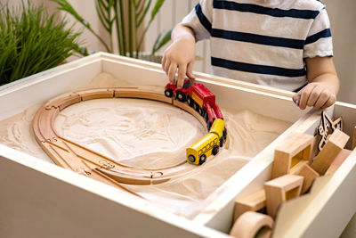 Midsection of woman playing with toy