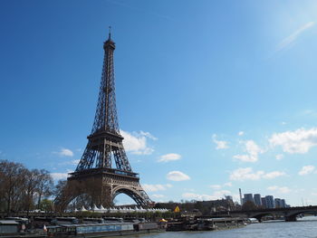 Eiffel tower against cloudy sky