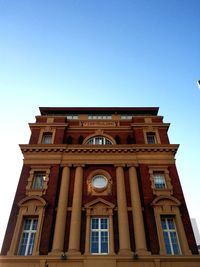 Low angle view of building against clear blue sky